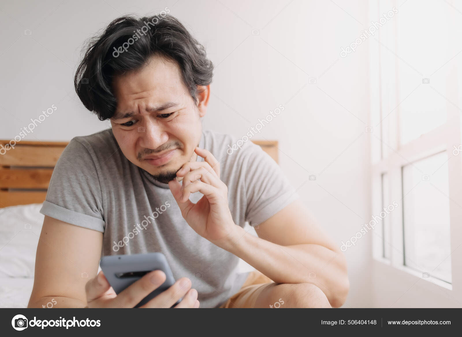 Sad man has bad online chat news and feels disappointed on the smartphone.  Stock Photo by ©sevendeman 506404148